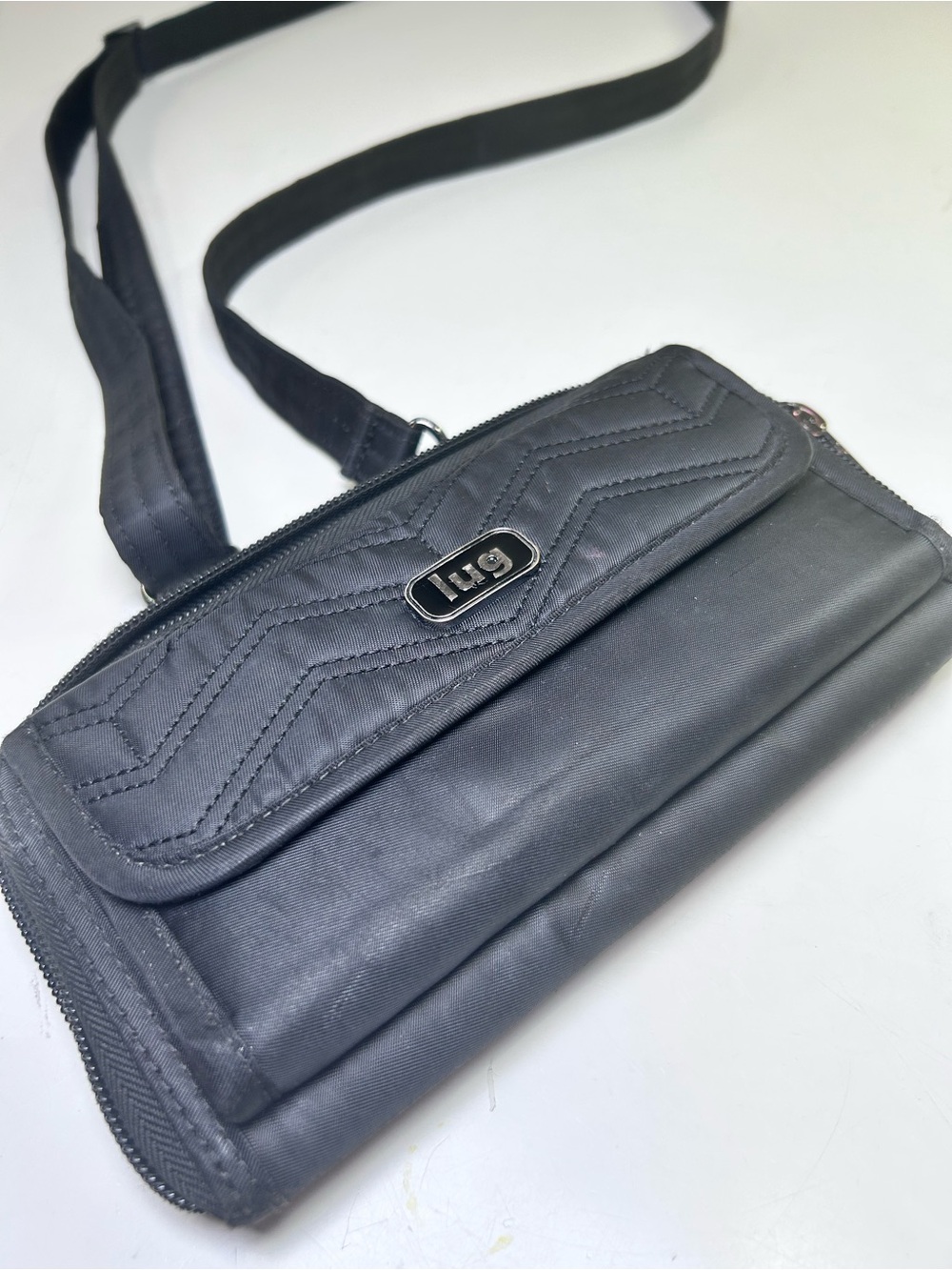 Lug Kickflip Convertible RFID Crossbody Wallet in black.